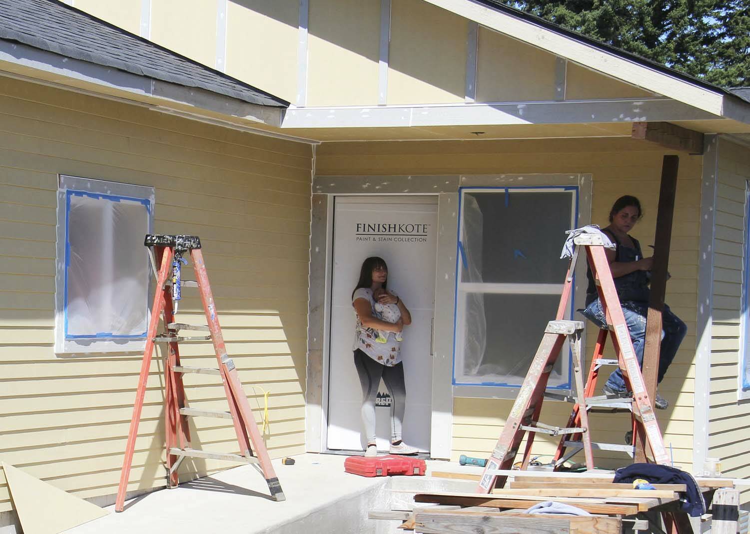 Several participants in the Mutual Self-Help build, on Maloney Lane, were prepping this house on Friday for painting that was to take place on Saturday.
