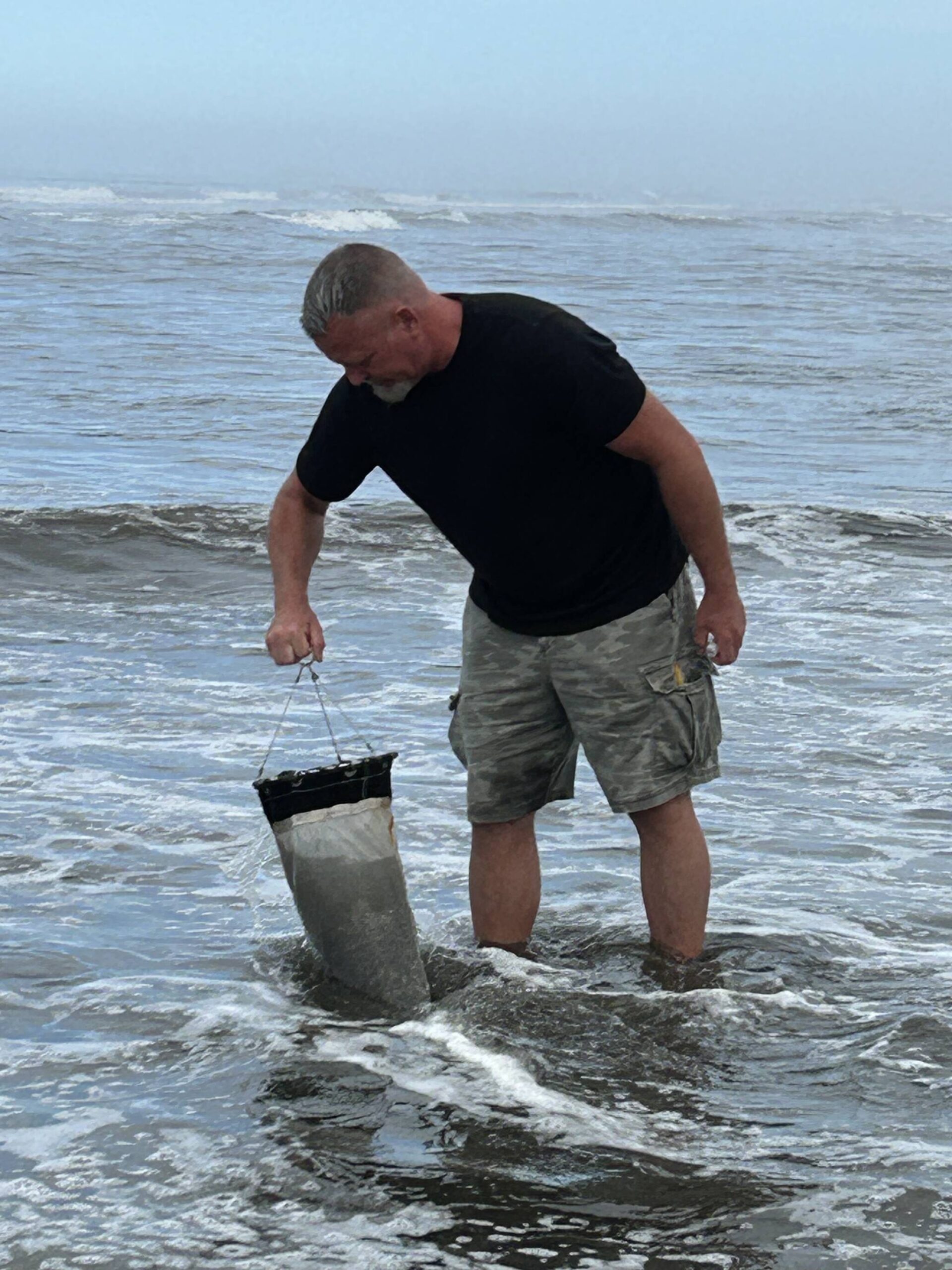 Anthony Odell, UW ONRC, sampling HABs at Kalaloch Beach, using a phytoplankton net.