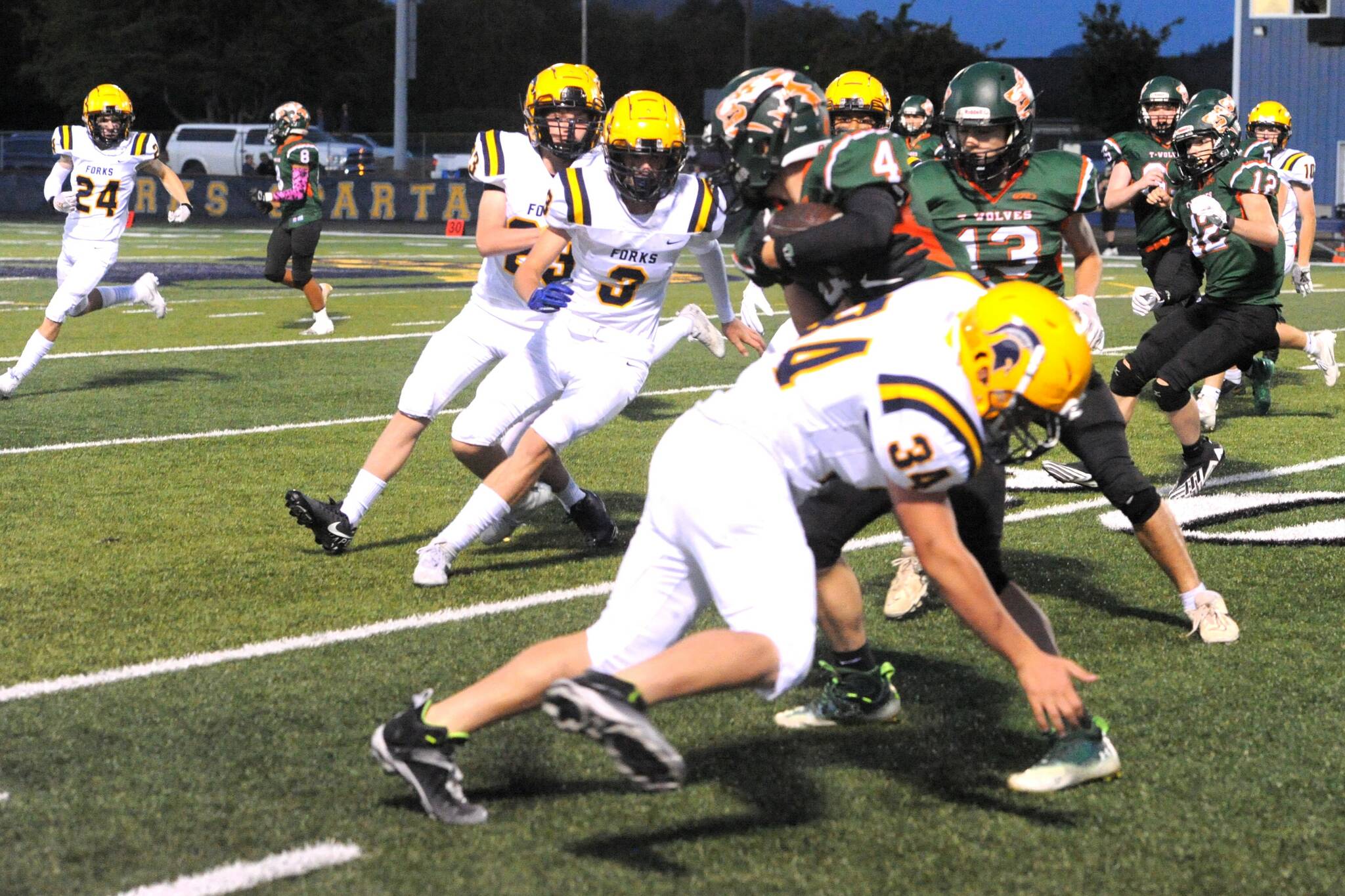 Spartan Landon Thomas attempts to bring down the Timberwolves running back while teammates Gage Willenbrink, Conner Roberts, and Walker Rondeau close in. Photo by Lonnie Archibald