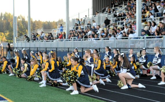 West End Youth cheerleaders joined the Forks High School cheerleaders during homecoming. Pictured here sportsmanship is shown as they kneel while an injured Timberwolves player is tended to. More on Spartan Homecoming on page 7. Photo by Lonnie Archibald