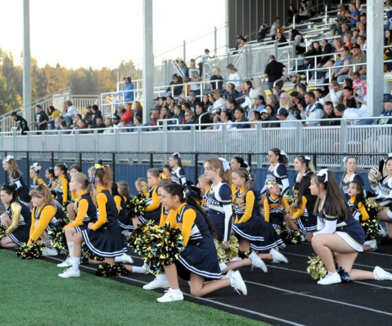 <p>West End Youth cheerleaders joined the Forks High School cheerleaders during homecoming. Pictured here sportsmanship is shown as they kneel while an injured Timberwolves player is tended to. More on Spartan Homecoming on page 7. Photo by Lonnie Archibald</p>