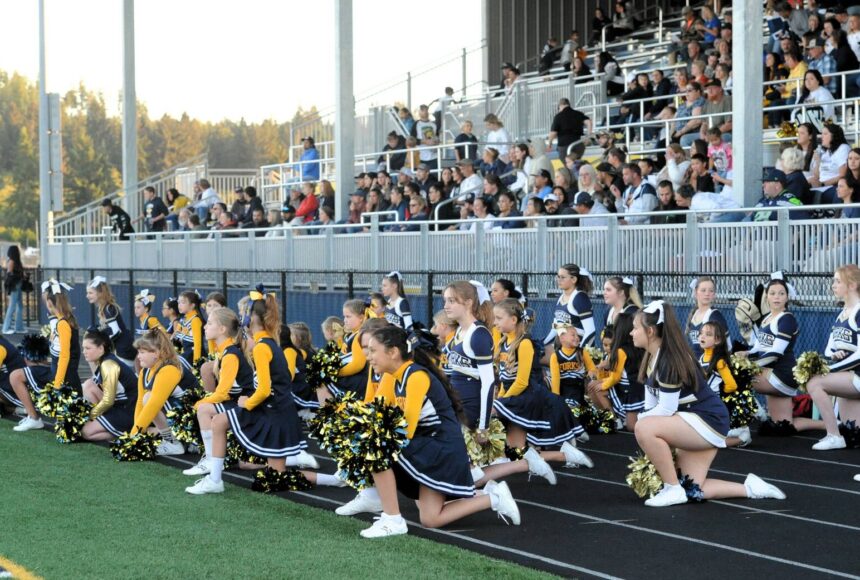 <p>West End Youth cheerleaders joined the Forks High School cheerleaders during homecoming. Pictured here sportsmanship is shown as they kneel while an injured Timberwolves player is tended to. More on Spartan Homecoming on page 7. Photo by Lonnie Archibald</p>