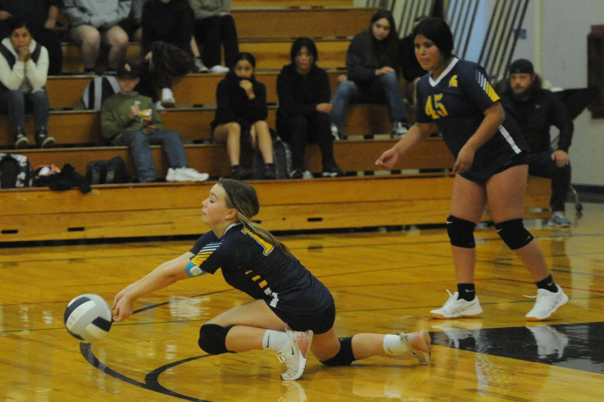 Spartan Katrina Clark digs it against Stevens of Port Angeles while Sophia Calderon looks on. Photo by Lonnie Archibald