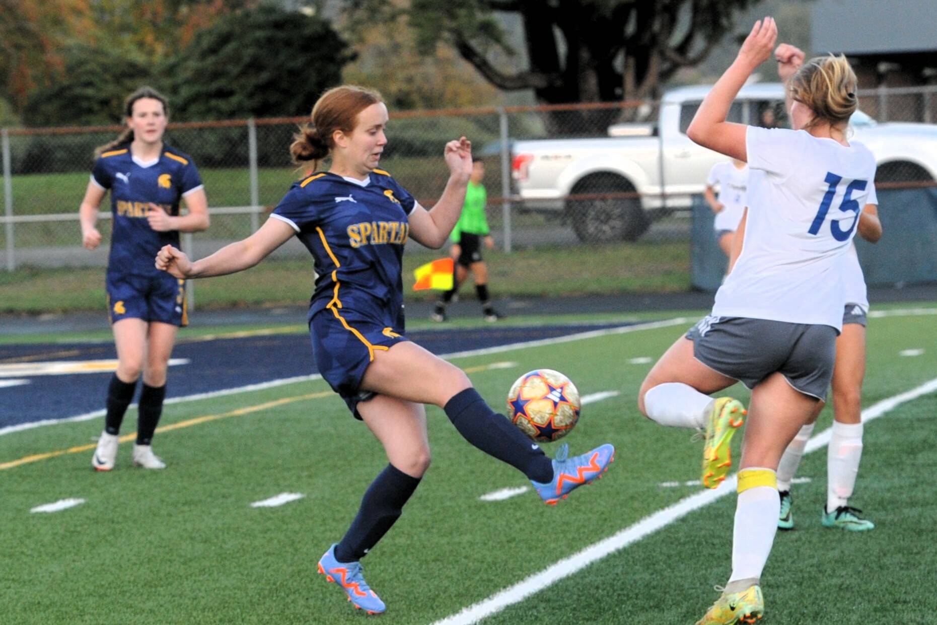 Forks’ Leilee Earls competes with Adna for ball control. Looking on is Spartan Keira Johnson. Photo by Lonnie Archibald
