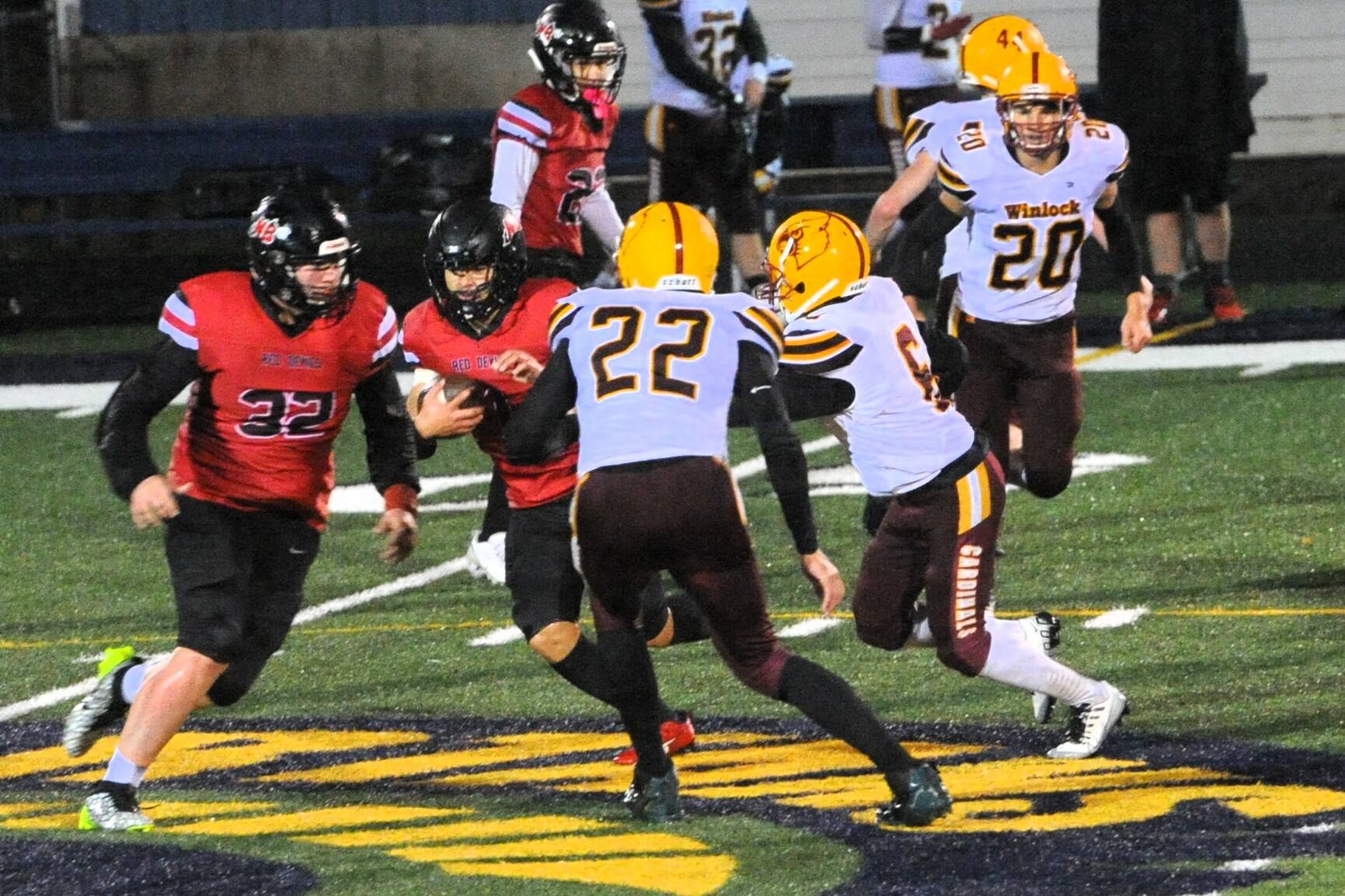 Neah Bay’s JoJo Wimberly looks for running room behind the blocking of Seactis Woodruff against Woodland during this State playoff at Spartan Stadium Friday evening. Photo by Lonnie Archibald