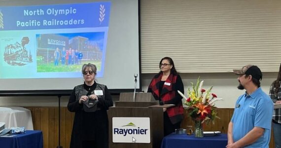 Rayonier Inc held its annual Community Fund Breakfast on Nov. 1 in Forks. Their Community Fund was the second donor for the project, pledging $2,000 a year for four years. Rayonier not only presented a check for the second installment of their pledge, but having seen so much community support, also raised their contribution by an additional $500. In case you don’t know, Rayonier is structured as a Real Estate Investment Trust, which means that substantially all their earnings must (by law) be paid out to their shareholders each year — and they cannot deduct charitable contributions. So, while the numbers don’t seem all that big to many folks, these are very big numbers for Rayonier. A big thank you to Judith Stipe, of North Olympic Peninsula Railroaders and the Sequim Museum, for attending the breakfast, receiving the check, and for presenting to the attendees about our project!