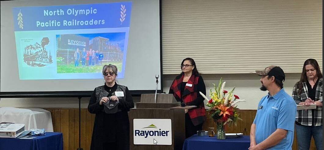 Rayonier Inc held its annual Community Fund Breakfast on Nov. 1 in Forks. Their Community Fund was the second donor for the project, pledging $2,000 a year for four years. Rayonier not only presented a check for the second installment of their pledge, but having seen so much community support, also raised their contribution by an additional $500. In case you don’t know, Rayonier is structured as a Real Estate Investment Trust, which means that substantially all their earnings must (by law) be paid out to their shareholders each year — and they cannot deduct charitable contributions. So, while the numbers don’t seem all that big to many folks, these are very big numbers for Rayonier. A big thank you to Judith Stipe, of North Olympic Peninsula Railroaders and the Sequim Museum, for attending the breakfast, receiving the check, and for presenting to the attendees about our project!