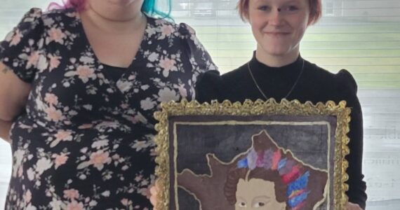 Kelsey and Amara with her art. In recognition of her achievement, Amara received a certificate and a coffee gift card. Submitted photo