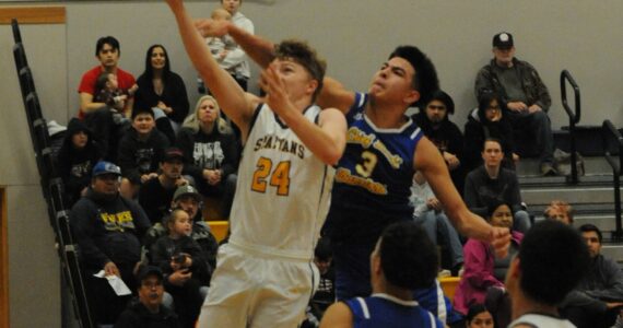 Spartan Landen Olson (24) and senior Aidan Salazar (2) in action against Chief Leschi who defeated the Forks 54 to 51 by way of a closing seconds three-point shot. Photo by lonnie Archibald