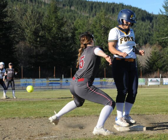 In their first home game of the season, Forks defeated Hoquiam 20 to 15 in a slugfest at the Fred Orr Memorial Park in Beaver. Forks is scheduled to play Montesano on Thursday, March 21 also in Beaver. The Spartan JV team lost to the Grizzlies 15 to 11. Forks Elizabeth Soto beats the throw to third. Photo by Lonnie Archibald