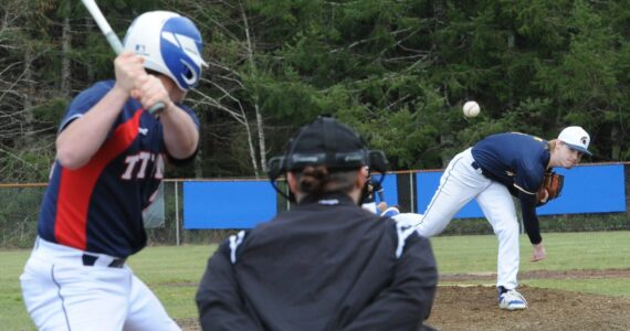 Spartan Gunner Rogers delivering the pitch was the winning pitcher in the first game. Photo by Lonnie Archibald