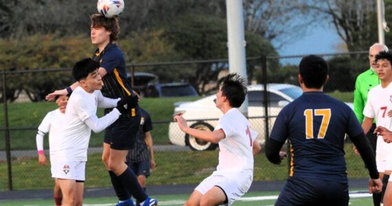 In soccer action Spartan Brody Owen is shown here with a header in this nonleague contest with 1A Hoquiam. The Grizzlies defeated Forks 4 to 0 on the turf of Spartan Stadium. Looking on is Forks’ Kevin Udave Ramos (17). Photo by Lonnie Archibald