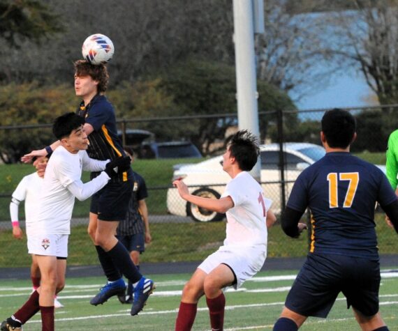 In soccer action Spartan Brody Owen is shown here with a header in this nonleague contest with 1A Hoquiam. The Grizzlies defeated Forks 4 to 0 on the turf of Spartan Stadium. Looking on is Forks’ Kevin Udave Ramos (17). Photo by Lonnie Archibald