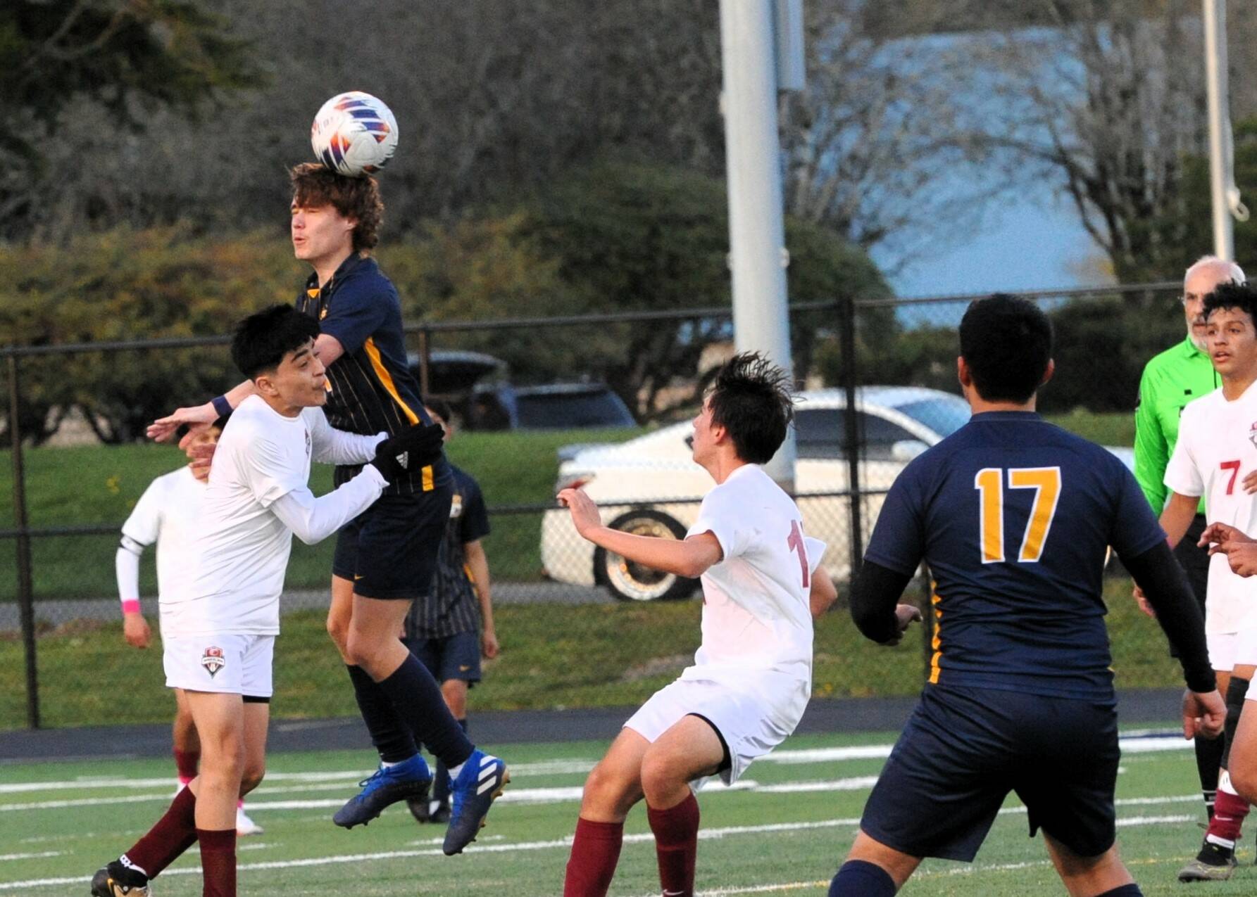 In soccer action Spartan Brody Owen is shown here with a header in this nonleague contest with 1A Hoquiam. The Grizzlies defeated Forks 4 to 0 on the turf of Spartan Stadium. Looking on is Forks’ Kevin Udave Ramos (17). Photo by Lonnie Archibald