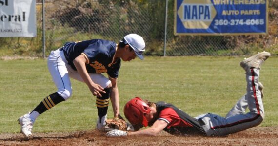 Spartan Aidan Salazar tags the Coupeville runner out at second in this nonleague game played Saturday at the Fred Orr Memorial Park in Beaver. Trailing 4 to 1 in the final inning, Forks came back to defeat the Wolves 5 to 4. Also on Saturday, the Spartan softball team defeated Coupville 11 to 2 at Tillicum Park. Photo by Lonnie Archibald