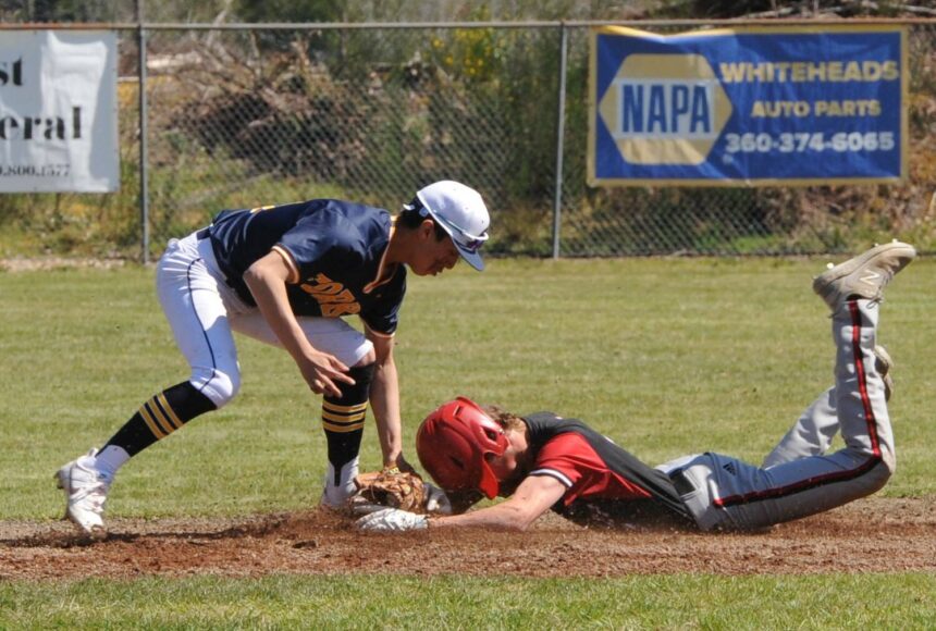 <p>Spartan Aidan Salazar tags the Coupeville runner out at second in this nonleague game played Saturday at the Fred Orr Memorial Park in Beaver. Trailing 4 to 1 in the final inning, Forks came back to defeat the Wolves 5 to 4. Also on Saturday, the Spartan softball team defeated Coupville 11 to 2 at Tillicum Park. Photo by Lonnie Archibald</p>