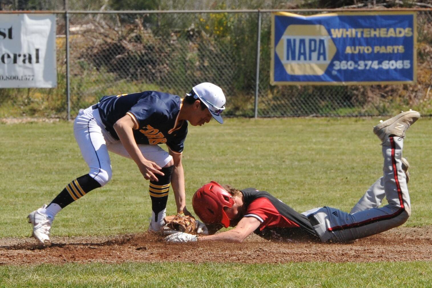 Spartan Aidan Salazar tags the Coupeville runner out at second in this nonleague game played Saturday at the Fred Orr Memorial Park in Beaver. Trailing 4 to 1 in the final inning, Forks came back to defeat the Wolves 5 to 4. Also on Saturday, the Spartan softball team defeated Coupville 11 to 2 at Tillicum Park. Photo by Lonnie Archibald