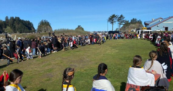 What a difference a year makes …last year Quileute students, tribal members and spectators battled wind and rain at the annual Welcome the Whales ceremony …this year the weather was amazing! Here students perform a dance and song as a very large crowd looks on. Submitted photo