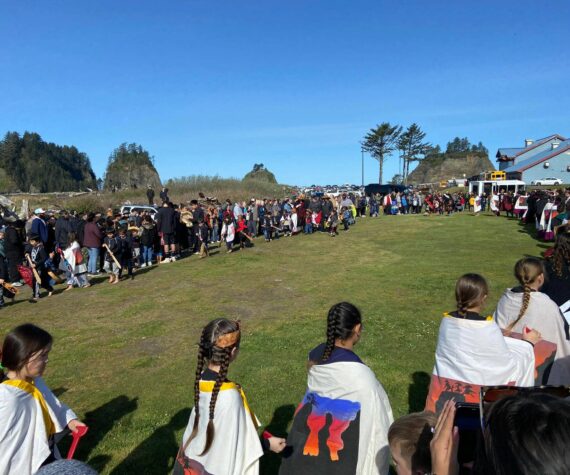 <p>What a difference a year makes …last year Quileute students, tribal members and spectators battled wind and rain at the annual Welcome the Whales ceremony …this year the weather was amazing! Here students perform a dance and song as a very large crowd looks on. Submitted photo</p>