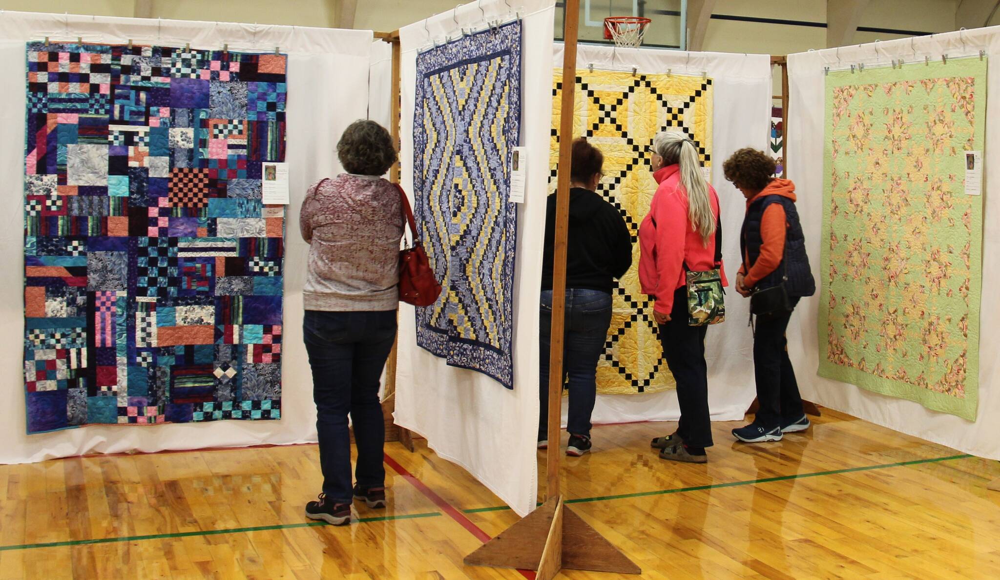 Over 100 beautiful quilts were on display over the weekend at the FHS auxiliary gym during the Piecemaker’s annual Fabric of the Forest Quilt Show. Here attendees take a closer look at some of the fine work done by local quilters. Winners of raffle items were - Quilts - Gretchen Fleck and Margaret Voyles; the gift basket winner was Pam Ogier. The club also offered several quilting classes. Photo Christi Baron