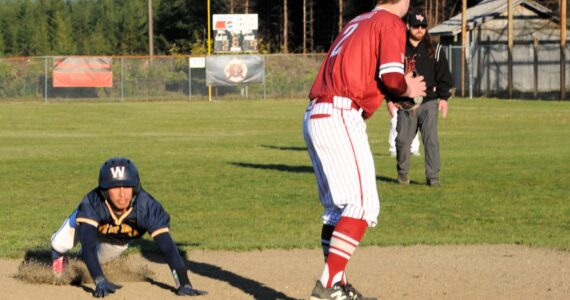 Spartan Aidan Salazar slides safely into third during this nonleague contest against Hoquiam played on April 18 at the Fred Orr Memorial Park. Forks won 13 to 3 with the ten-run rule in the 6th inning. Photo by
Lonnie
Archibald