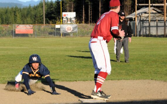 Spartan Aidan Salazar slides safely into third during this nonleague contest against Hoquiam played on April 18 at the Fred Orr Memorial Park. Forks won 13 to 3 with the ten-run rule in the 6th inning. Photo by
Lonnie
Archibald