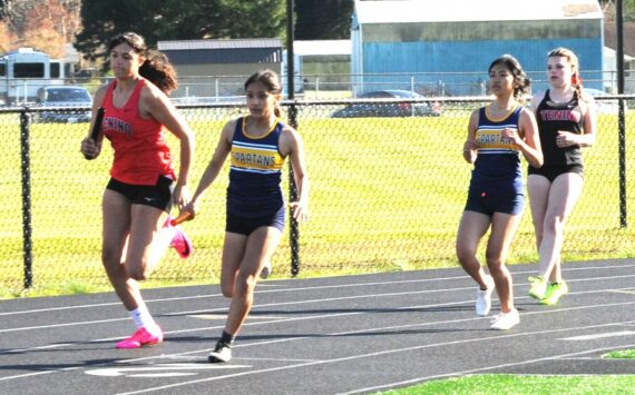 Spartan Marysleidy H Beltran took the handoff from teammate Moli Luong in the first leg of the 4x100 relay won by Forks. Finishing the race, not shown, are Alie Coons and Natalie Horejsi. Photo by Lonnie Archibald