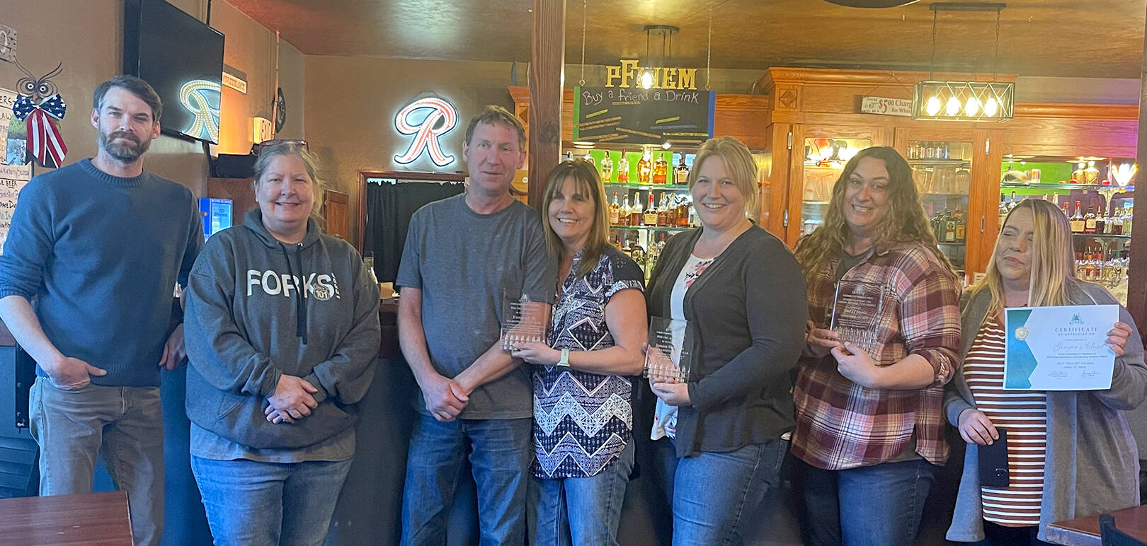 Pictured L-R Forks Chamber of Commerce President Trent Thurman, Forks Chamber Executive Director Lissy Andros, Business of the Year award winners Shane and Devennie Anderson owners of Evergreen 76/Subway, Volunteer of the Year recipient Jessica Sorenson, and special Halvy Award winners from Ginger’s Closet/Disaster Relief Sena Engeseth and Executive Director of Ginger’s Closet Layla Rawls. Not picture Citizen of the Year Susie Brandelius (DSHS/AAA/OLYMPIC) Photo Christi Baron