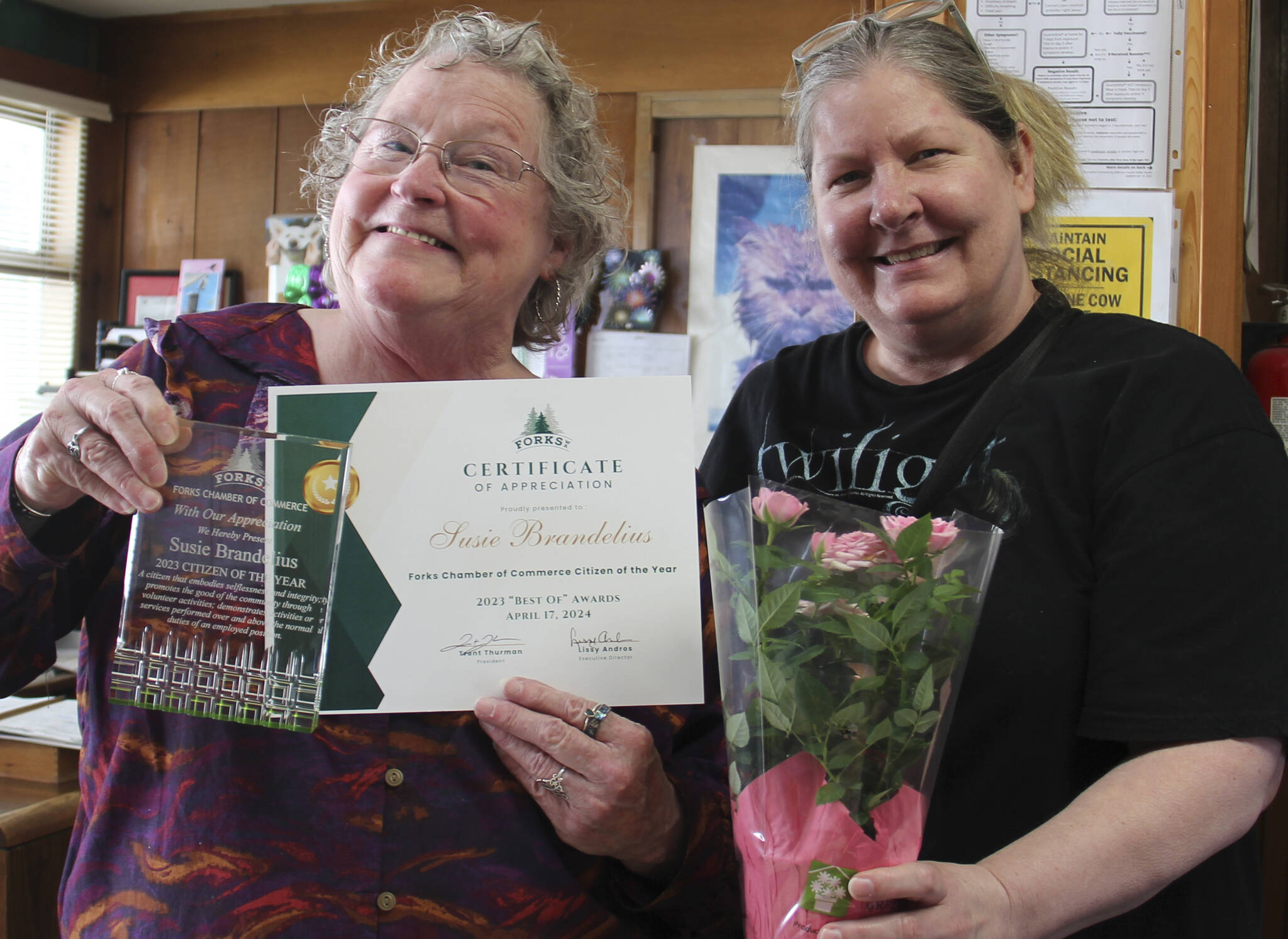 Citizen of the Year Susie Brandelius was unable to attend the Forks Chamber of Commerce Best of Awards event on April 17. She is seen here with the Forks Chamber of Commerce Executive Director, Lissy Andros, who caught up with her on Monday, April 22 at her office to present her award and flowers. Susie was recognized for helping seniors in the community as well as helping with resources for relatives raising relatives and more. Photo Christi Baron