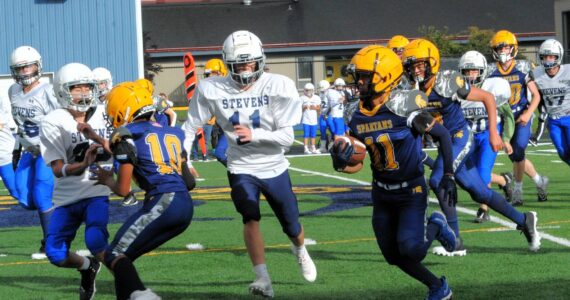 In Forks Middle School football, Stevens of Port Angeles just got by Forks with a 31 to 28 score in this thriller. Pictured here Spartan Pedro Francisco Marcos (11) picked up good yardage behind the blocking of Thomas Penn (10). The next home game is scheduled for Oct. 9 at 4 p.m., against Sequim. Photo by Lonnie Archibald