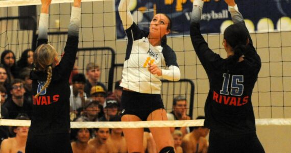 Spartan Avery Dilley (11 ) hits against East Jefferson’s Emily Lisk (8) and Penina Vailolo (15) on Sept. 26 in the Spartan Gym where Forks, after losing the first set, came back to defeat the Rivals 3 to 1 in this nonleague contest. Photo by Lonnie Archibald