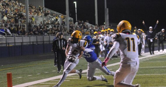 Forks coach Trevor Highfield signaled TD and he was correct as Spartan Noah Foster pulled in a Forks pass for the touchdown in front of a large crowd at Spartan Stadium putting Forks ahead 14 to 13 at the half against the Adna Pirates. Also in the photo is Spartan Cash Barajas (11). Photo by Lonnie Archibald