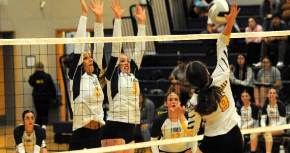 There was a lot of hustle and some great saves shown by both teams at the Spartan Gym on Thursday, Oct. 11 where Forks defeated North Beach 3 to 0. Pictured here going for the block are Spartans Avery Dillley and Keana Rowley. Backing up the play are Chloe Gaydeski (6) and Fyn Peters (12). Photo by Lonnie Archibald