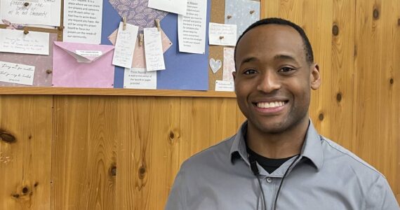 Tilus stands in front of the newly added Prayer Board at the pharmacy, where anyone can share a prayer request. “We start our day with prayer—who doesn’t need a little prayer sometimes?” he said.