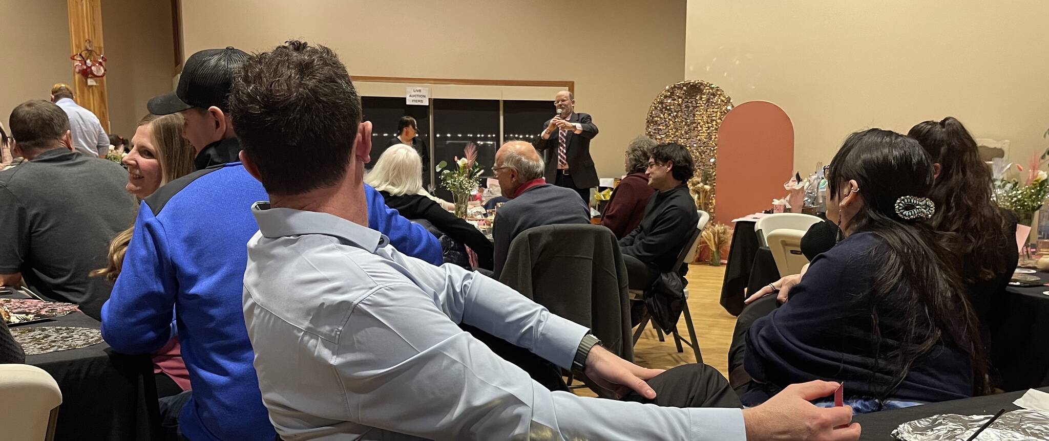 Photo Christi Baron
Rod Fleck stands at the front of the RAC Saturday evening as he served as the auctioneer to raise funds for a 3-D Mammography machine for FCH.