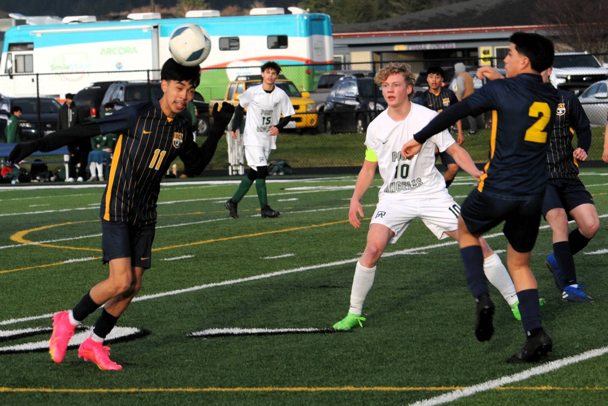 Forks’ Margarito Gonzalez Black was really using his head on this play while teammate Estevan Ramos (2) looked on. Roughrider is Mathew Miller (10).