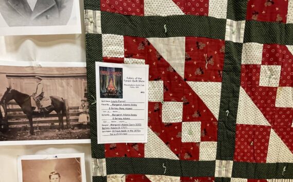 Around 100 quilts were on display over the weekend in the auxiliary gym for the annual Fabric of the Forest Quilt Show. Some were new creations and some were very old. This quilt made in 1870 is a family treasure owned by Laura Farrell complete with family photos. 
Photos Christi Baron