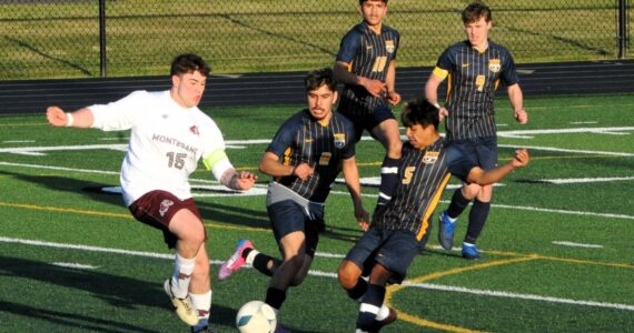Photos by Lonnie Archibald
Spartans DeAnthony Davila (8), Orlando Camacho (5), Abraham Montealegre (10), and Brody Owen (9) on the defense against the Bulldogs, whom Forks defeated on the turf of Spartan Stadium on April 15.