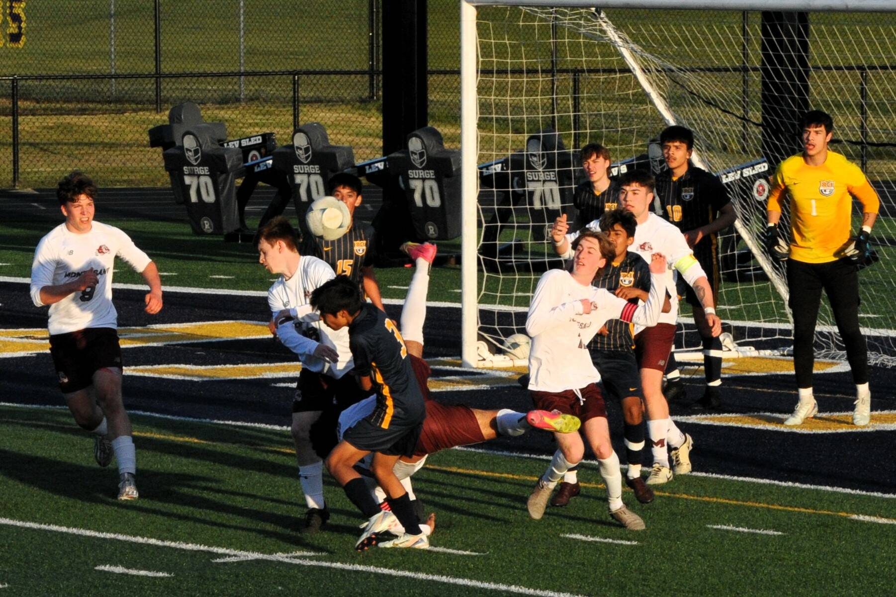 Adan Montealegre (3) with a header at the net.