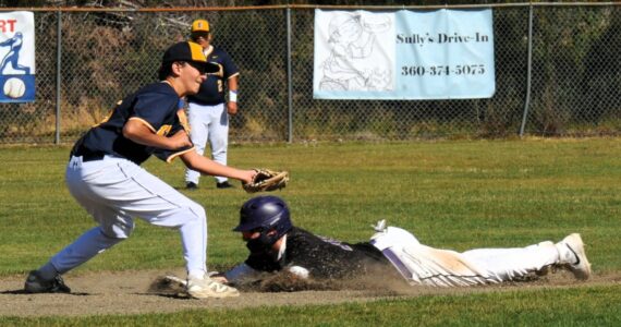 Photo by Lonnie Archibald
The Sequim runner steals second as Spartan second baseman Mason Dent makes the tag. 2A Sequim defeated the Spartans 15 to 9 in this non-league contest.