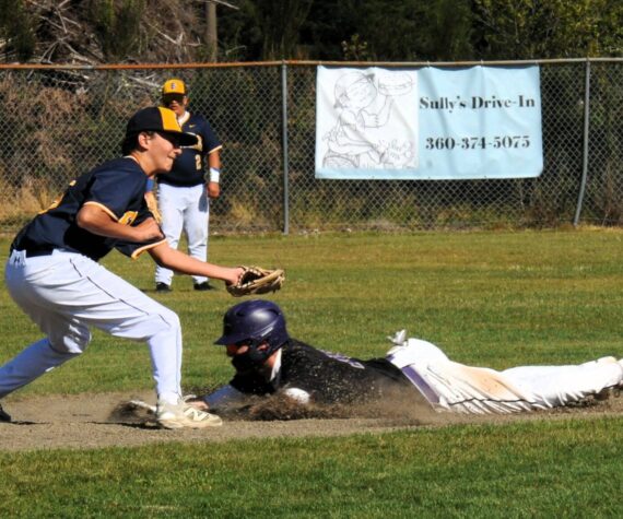 Photo by Lonnie Archibald
The Sequim runner steals second as Spartan second baseman Mason Dent makes the tag. 2A Sequim defeated the Spartans 15 to 9 in this non-league contest.