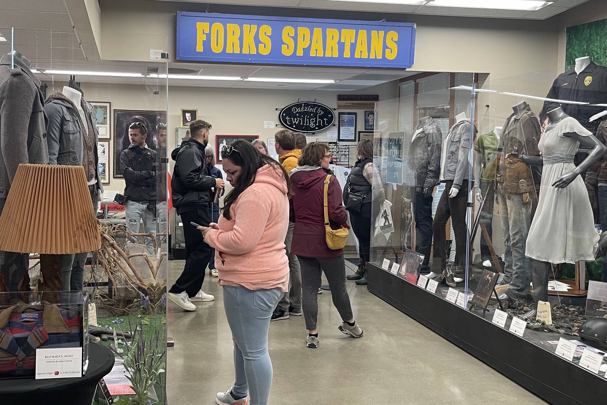 Edelweiss Air’s media delegation, hosted by SWT and the Port of Seattle, visited Forks on May 2 with stops at the Sasquatch Store/Museum and Forever Twilight in Forks Collection as part of a regional tour promoting new Zurich-SEA direct flights. Here the group looks over the FTF Collection as Forks Chamber Executive Director Lissy Andros shres information about the Twilight memorabilia. Photo Christi Baron