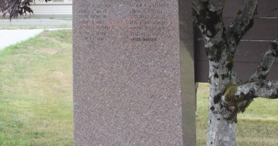 Photo Christi Baron
The monument at Forks City Hall honors the memory of fourteen West End servicemen who gave their lives in service to our country. Their names—Walter Fletcher, Arthur Wittenborn, George Welch, Lorrell Cassell, Frank Daman Jr., S. George Vogel Jr., Robert Price, Earl Brandeberry, Arthur Munson Jr., Norman Lodholm, Vernon Depew, Douglas Foster, Donald Kraft, and Jason Hanson—are etched in remembrance. Dedicated by VFW Post #9106.