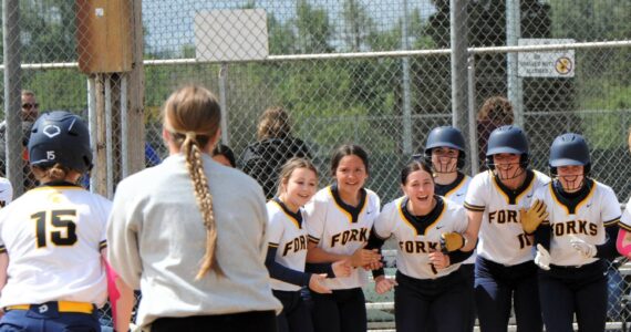 Photos by Lonnie Archibald
Spartan teammates await at home plate as Forks 8th grader Brooklynn Rondeau rounds the bases with a home run against Napavine. Brooklynn also hit a two-run homer against Rainier in the second game during this 2B District 4 playoffs held in Centralia.