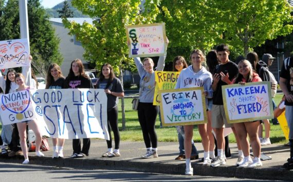 Signs support the Spartan track and field team as students wait in front of the Forks High School for the bus en route to Yakima last week. Photo by Lonnie Archibald