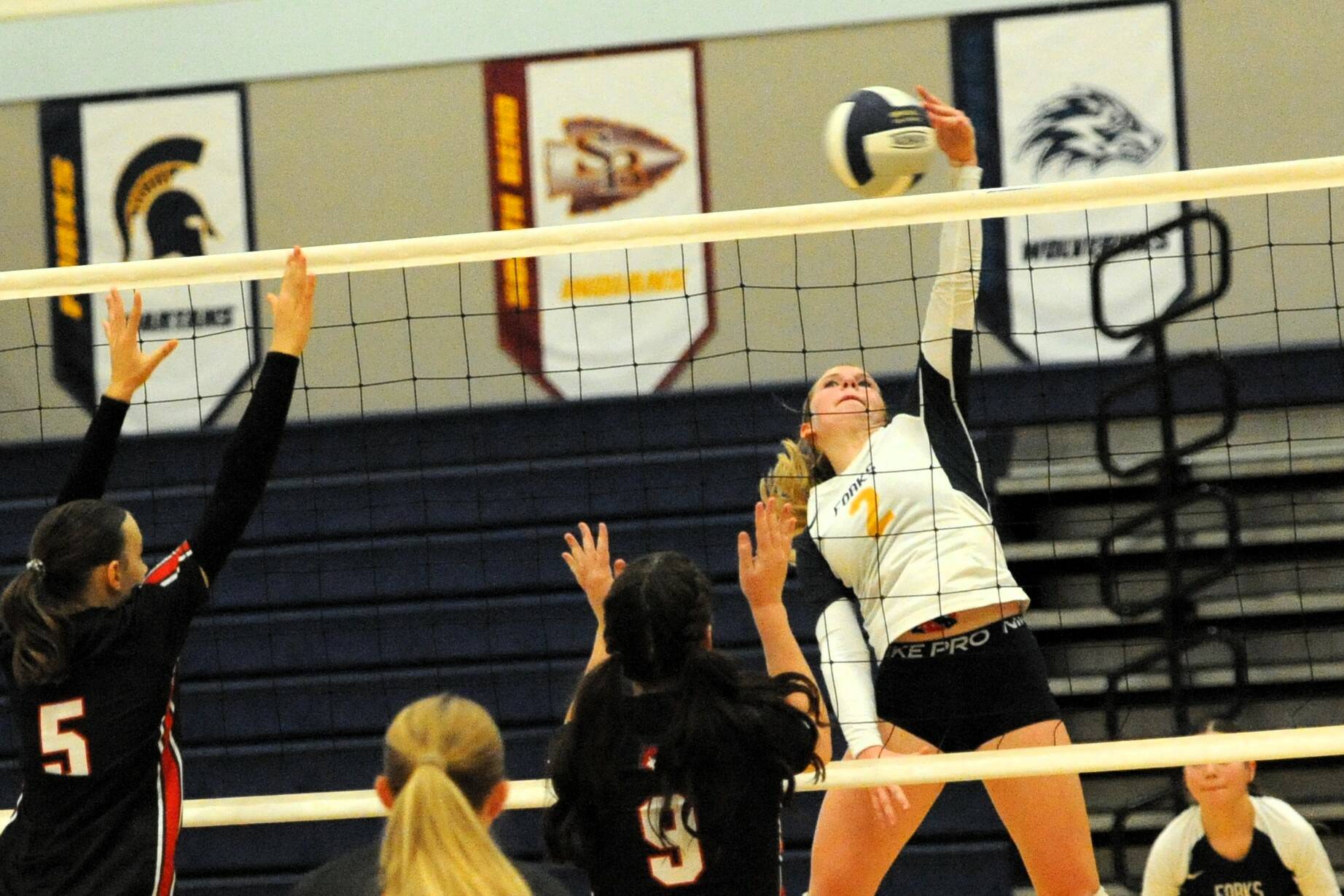 Photo by Lonnie Archibald
With Kylie Hull looking on, Spartan Bailey Johnson (2) goes for the spike against Coupeville in the Spartan Gym, where the two teams ended in a 2 to 2 tie as Coupeville had a ferry to catch.