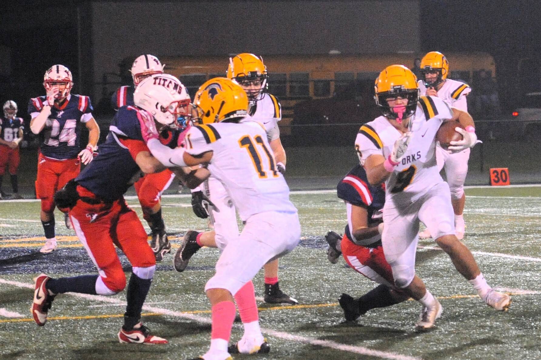 Spartan Kade Highfield runs behind the blocking of Cash Barajas (11) on the Turf of Spartan Stadium, Friday, Oct. 17, against the Trojans.