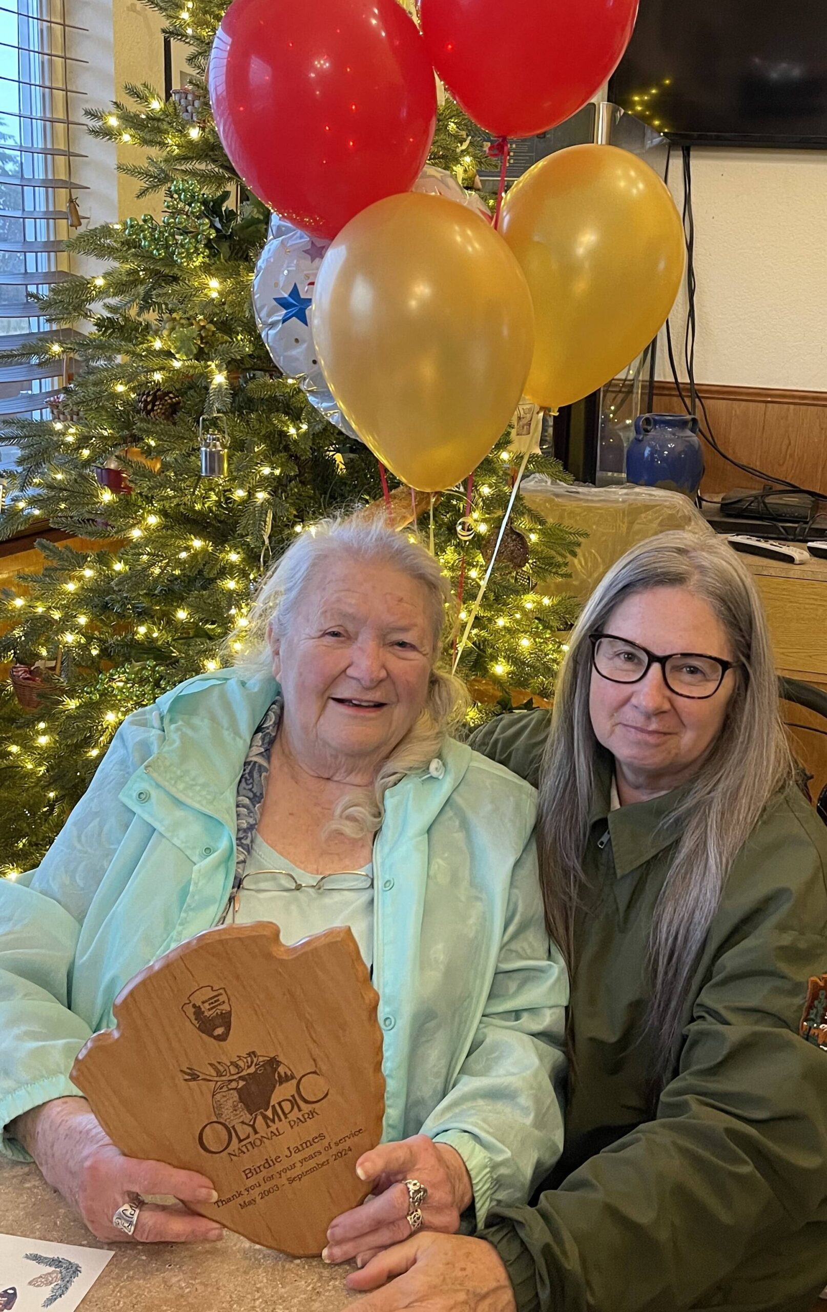 Photo Christi Baron
Birdie with her Arrowhead plaque and ONP representative Heather Stephens. The back of the plaque was covered in well wishes from former co-workers and others.
