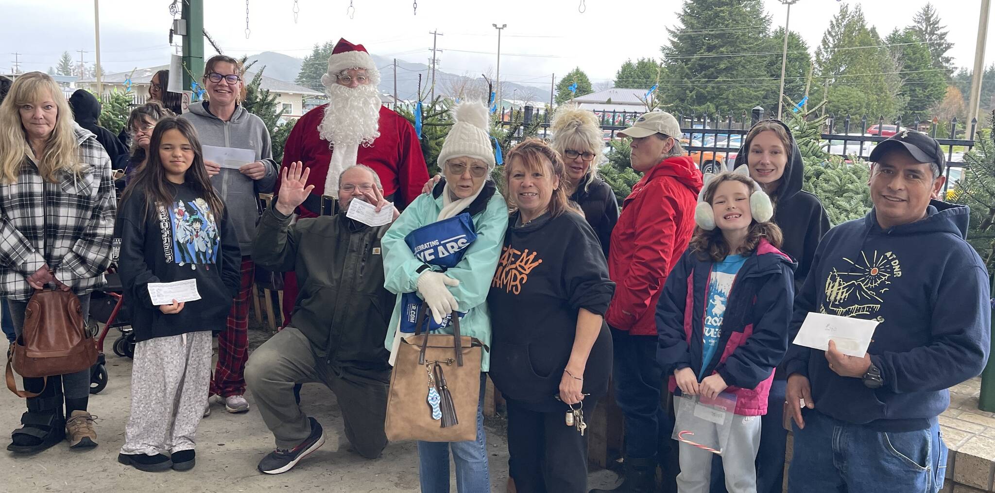 Photo Christi Baron
West End Business and Professional Association wrapped up its holiday Promotion on Saturday, Dec. 20 outside Forks Outfitters. Winner for the last week were - Santa Bucks - Martin Perez $200, Rita Enlow $50 and Shelli Leons $25; winners of Outfitters giftcards were - Cathy Harner, Lori Crippen, Gabby Salsgiver, Eliza Hull, Tammy Jordan, David Tenorio, Nikole Gaydeski, and Pyper Graham; winners of Sullys gift certificates were - Edward Stringer, Walter Jackson and Athena Ward. Thanks to all who shopped local, and thanks to Outfitters, Sullys, and Chinook Pharmacy for adding to the prizes. A special thanks to Santa for his help. Winners pictured here are - Tammy, Athena, Rita, Santa, Edward, Cathy, (Joanne photo bombing), Shelli, Lori, Eliza, Nikole, and Martin.