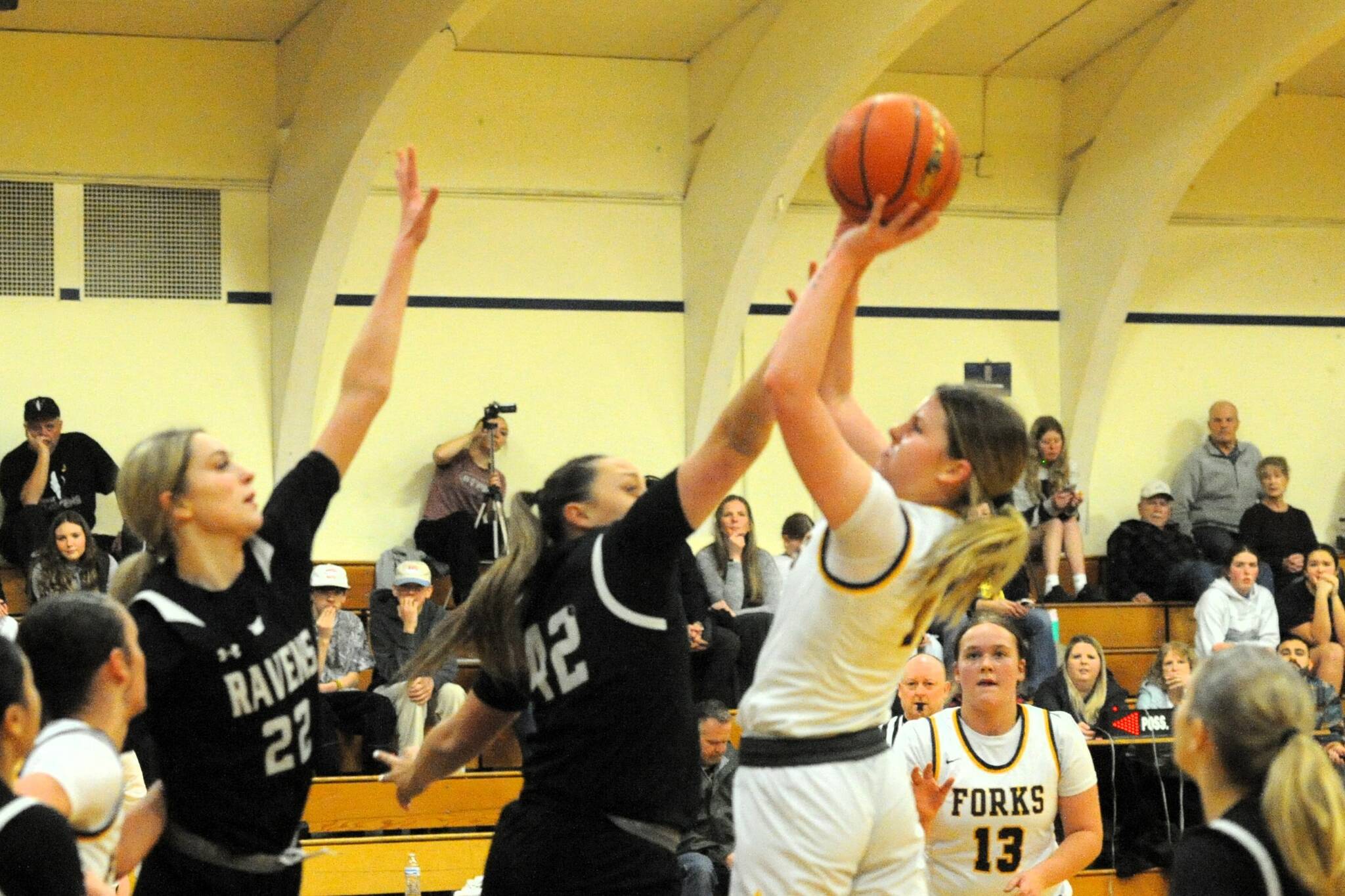 Photo by Lonnie Archibald
Spartan Bailey Johnson in action here, scoring two of her twenty-seven points against Raymond-South Bend. Looking on is Fynlie Peters (13). Forks won this league contest in a hard-fought battle.